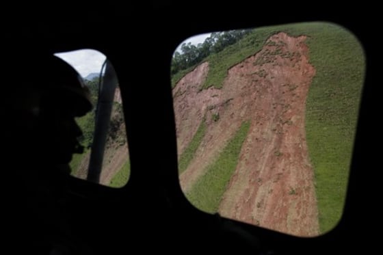 A helicopter crew looks for survivors and victims on Tuesday in the area around Teresopolis, Brazil.